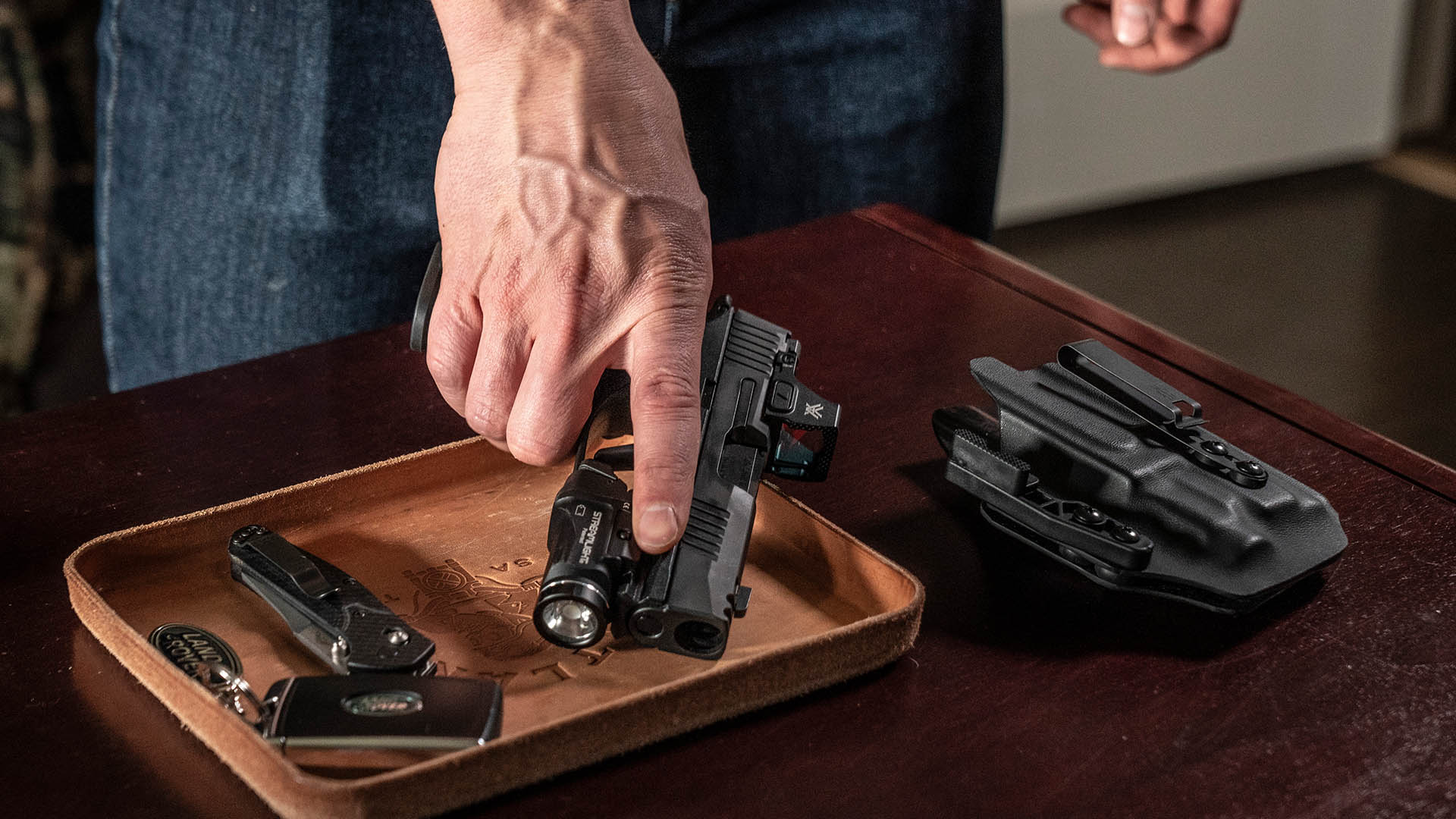 Man setting firearm down on a table