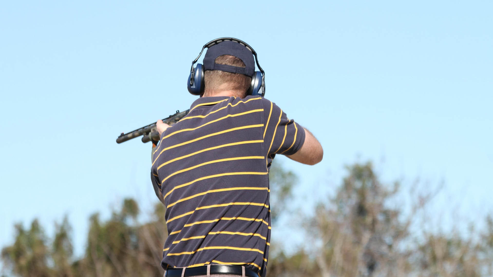 Man shooting a gun outside