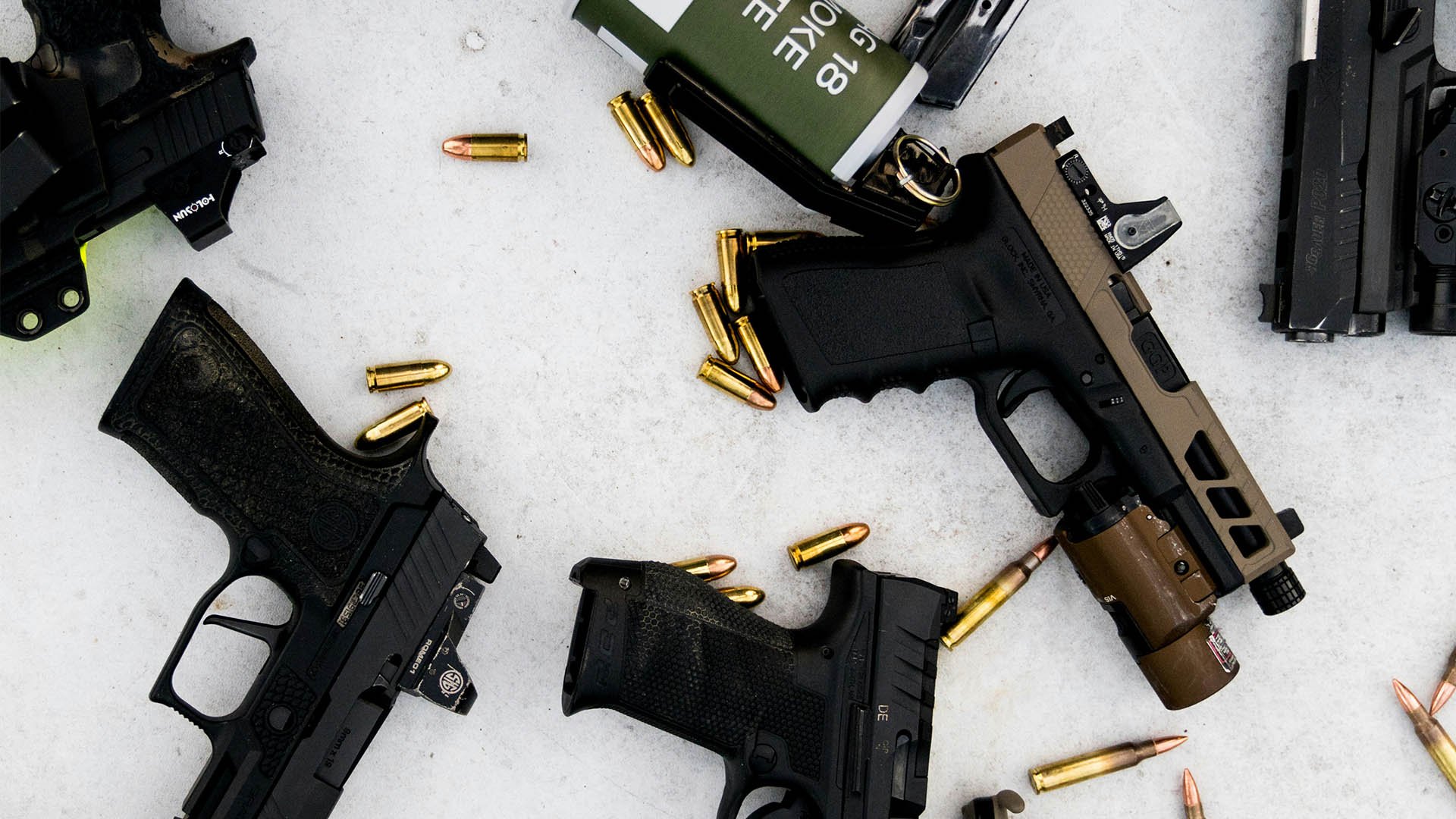 pistols surrounded by cartridges