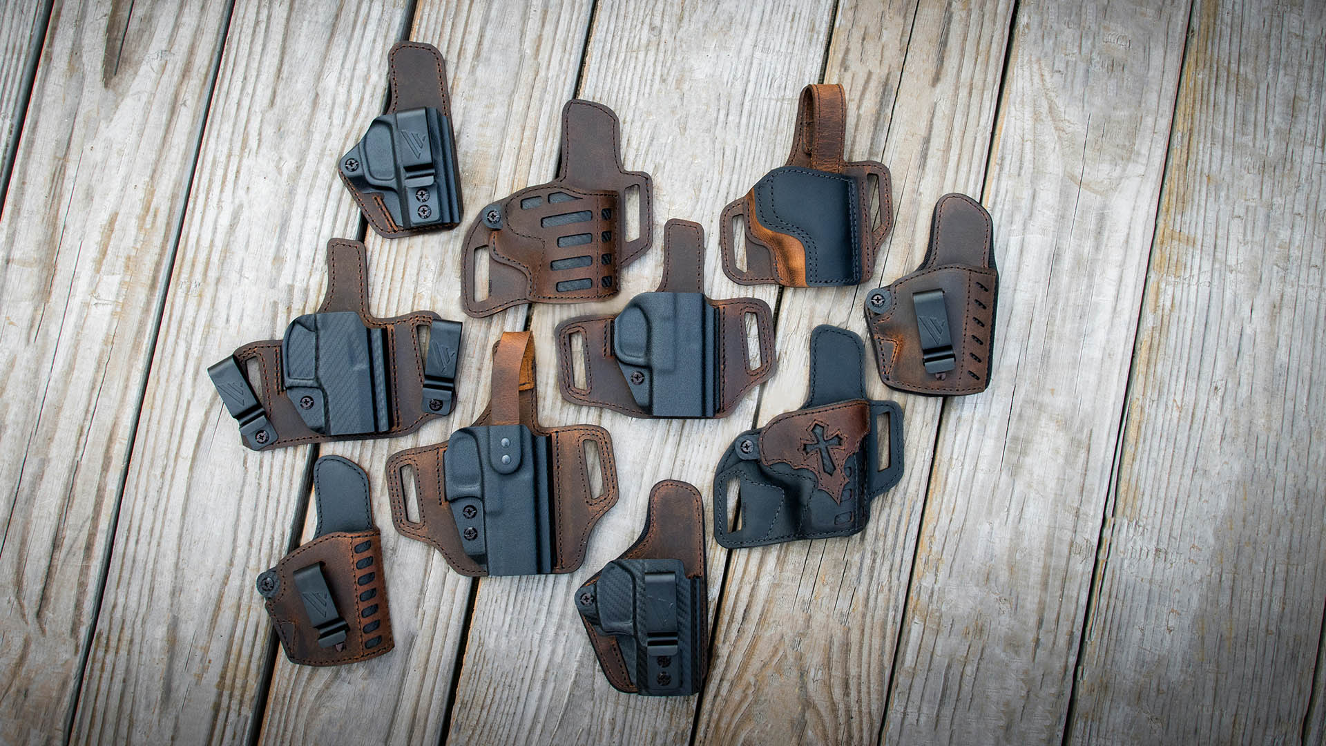 Several concealed carry holsters on wooden planks